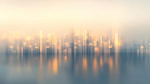 A dreamy morning urban landscape with blurred buildings and soft pastel colors.

