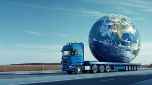 This image depicts a blue truck transporting a globe, symbolizing global logistics and the trucking industry.

