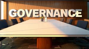 This image showcases a modern conference room with &quot;GOVERNANCE&quot; prominently displayed, symbolizing corporate governance.

