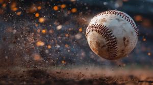 This image features a baseball in mid-air, surrounded by dust, capturing the excitement of the sport.
