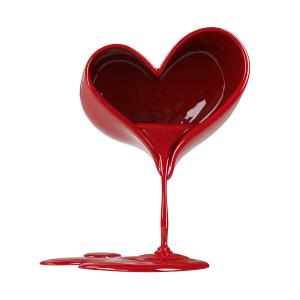 A heart-shaped container overflowing with red liquid, symbolizing emotional expression and love.