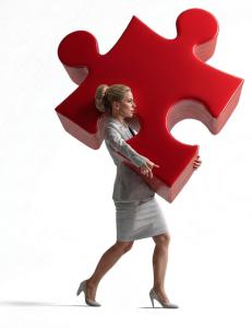 Download this Presentation Clipart of a woman holding a giant puzzle piece to enhance your presentation design with teamwork themes.