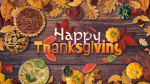 Edit this Thanksgiving video with your own text. Colorful fall leaves, gourds, and festive pies decorate a wooden table top.