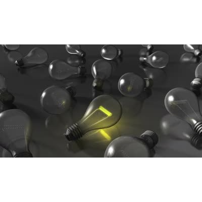 One light bulb out of many glows. This video can represent one person having an idea, or standing out from the crowd.