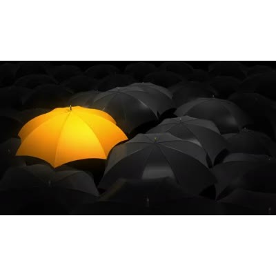 A gold umbrella subtly shifts back and forth among many black umbrellas.