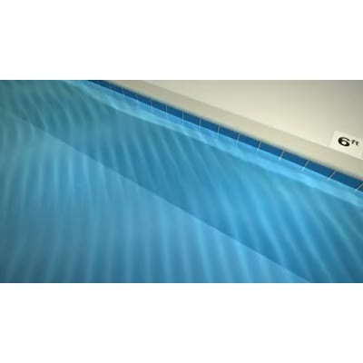 This video shows a swimming pool edge with rippling water.