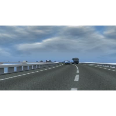 Cars and trucks on a road pass by on either side of the camera.