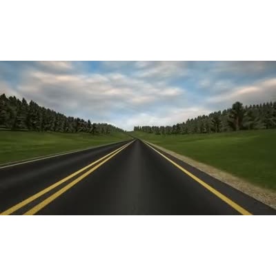 We travel on a road winding through hills filled with trees.