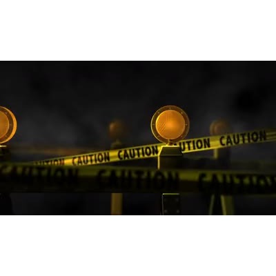 Caution tape and lights move towards the camera going into and out of focus.