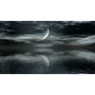 A moon is shown reflecting of a body of water.