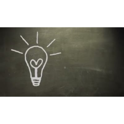 A chalk light bulb doodle is animated on a blackboard.  A video background for a good idea or moment of epiphany. 