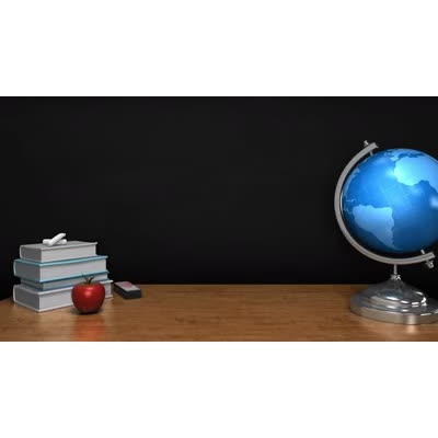 This video zooms in on a school blackboard zooming past a desk with books, an apple and a globe on it.