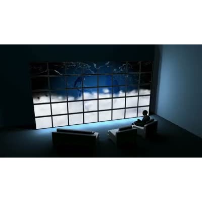 A traveler is shown sitting in the lounge waiting for his flight