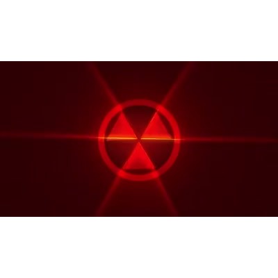 A hazard sign rotates in front of a red abstract background.