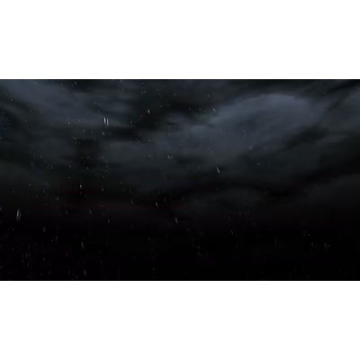 Rain falls from clouds on a stormy night.