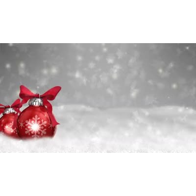 This video shows snow falling around ornaments with bows.