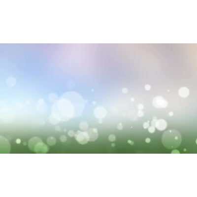 A blurred background of a sky and meadow with abstract dust particles floating in the air.