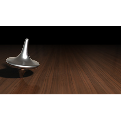 A metal top spins on a wooden table.