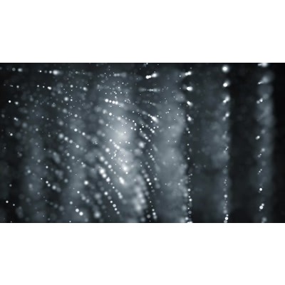 White dots ripple across a black surface.