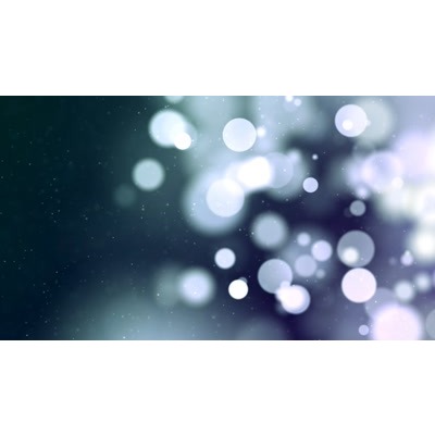 Colorful particles floating across a darkened background.