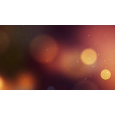 Particles drifting across a dark surface.