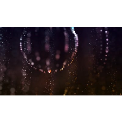 Rotating open space of lighted particles.