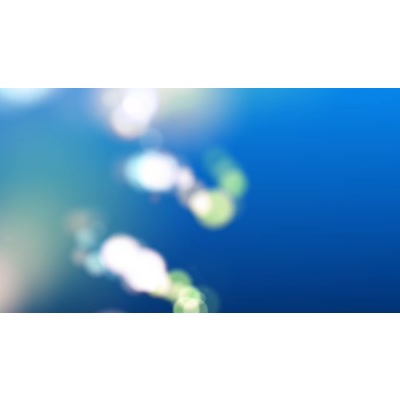 Gleaming colorful particles floating across a blue abstract background.